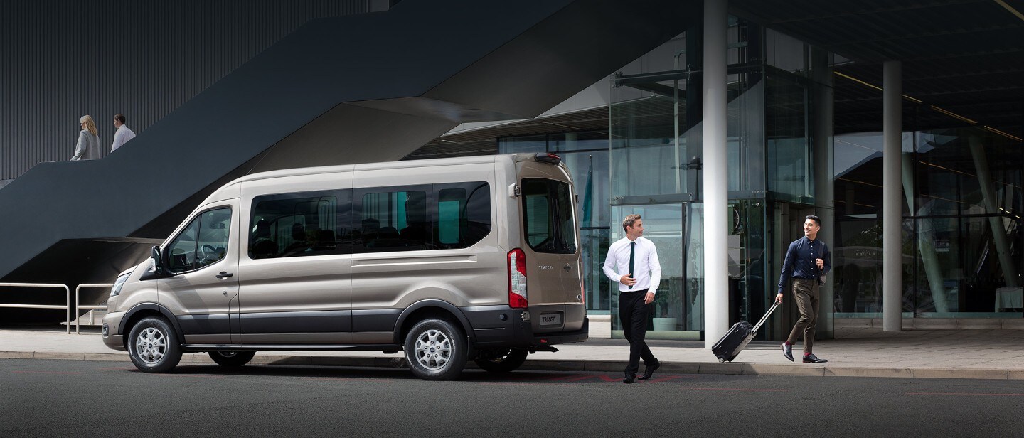 All New Ford Transit Minibus side view parked outside building
