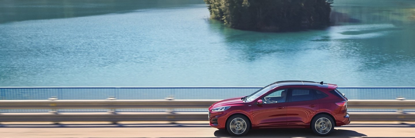 Ford Kuga image of car driving a coastal road and cornering