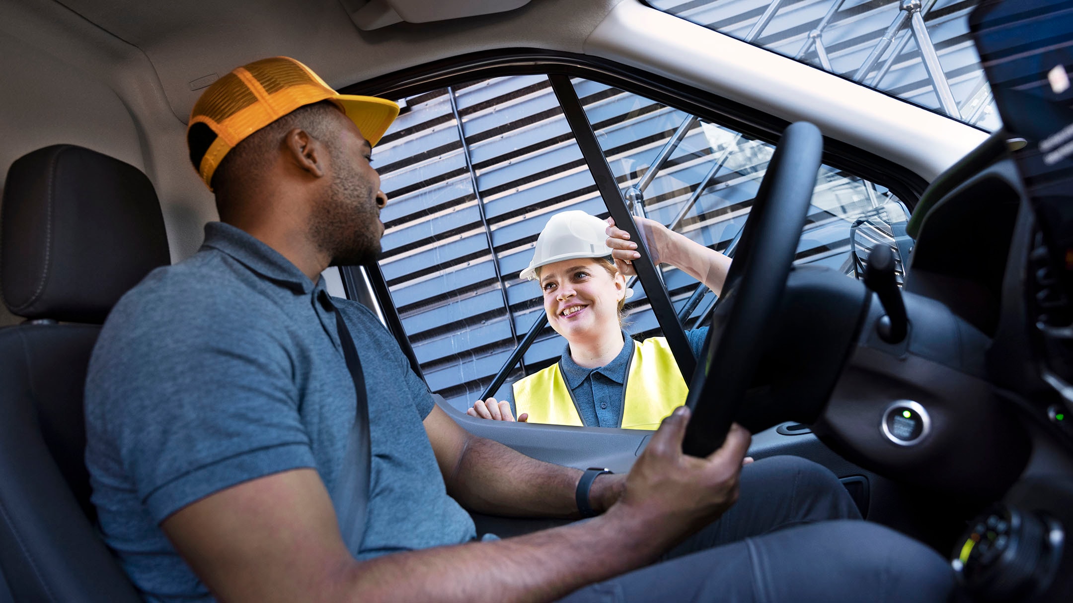 Driver and person next to car speaking