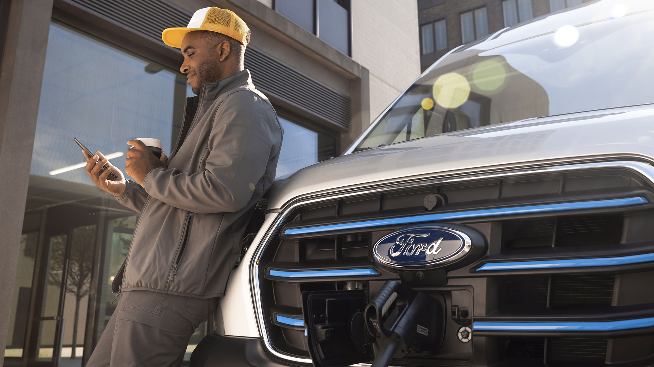 Person standing next to charging Ford Van