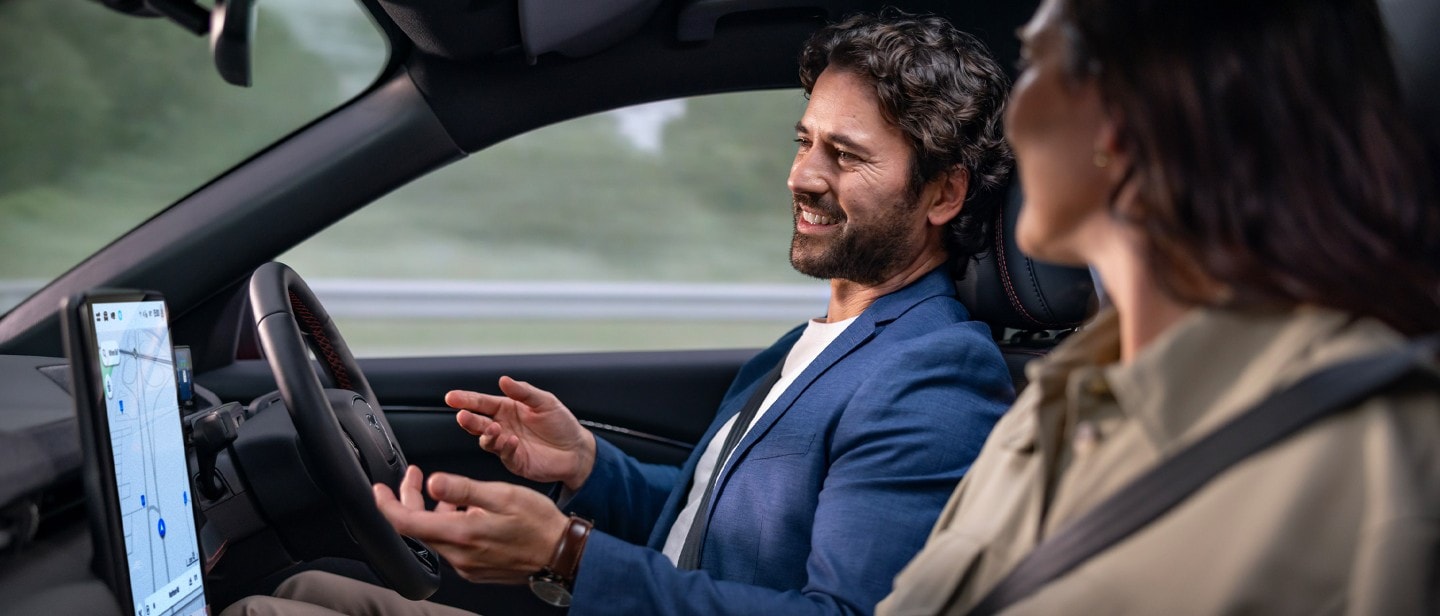 Two people sitting in a car and driving with BlueCruise.
