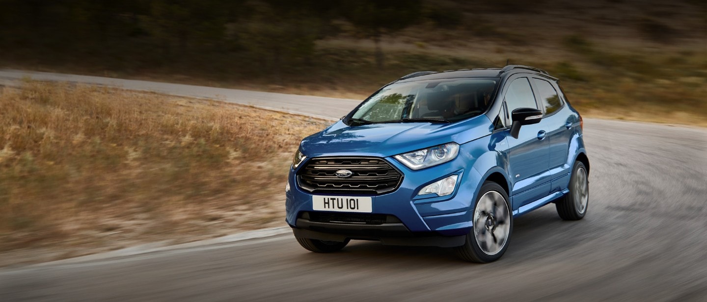 Blue Ford Ecosport ST-Line driving downhill on road