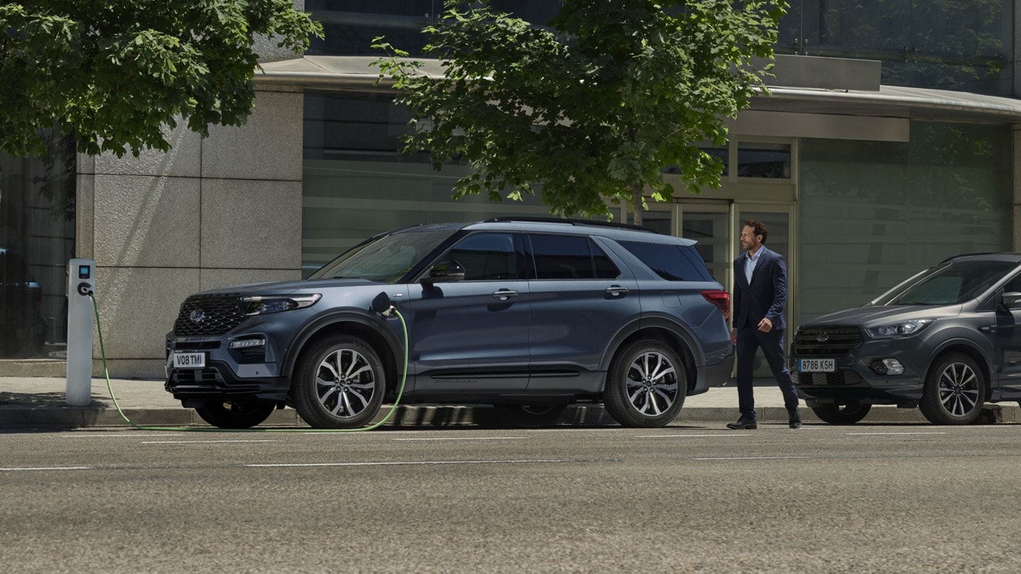 Ford Explorer side view being charged on public charger