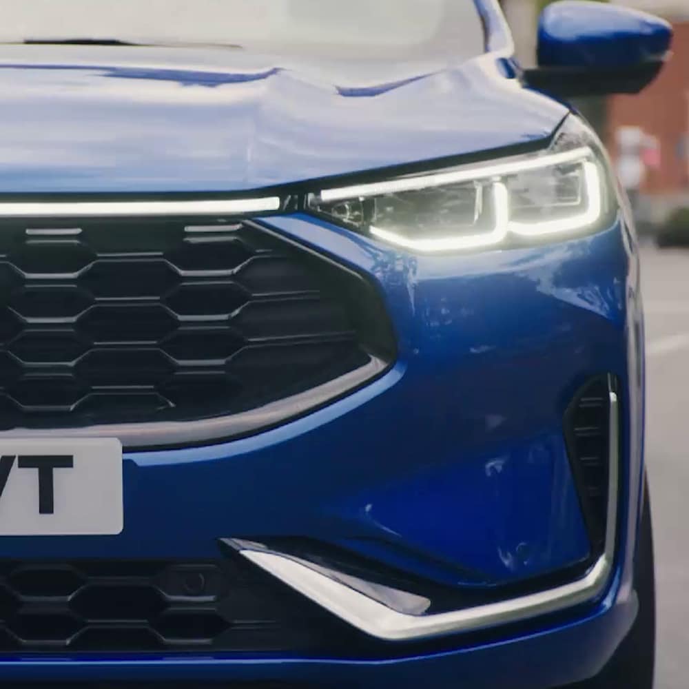 Detalle de los faros delanteros afilados de un Ford Kuga, destacando su diseño moderno y tecnológico