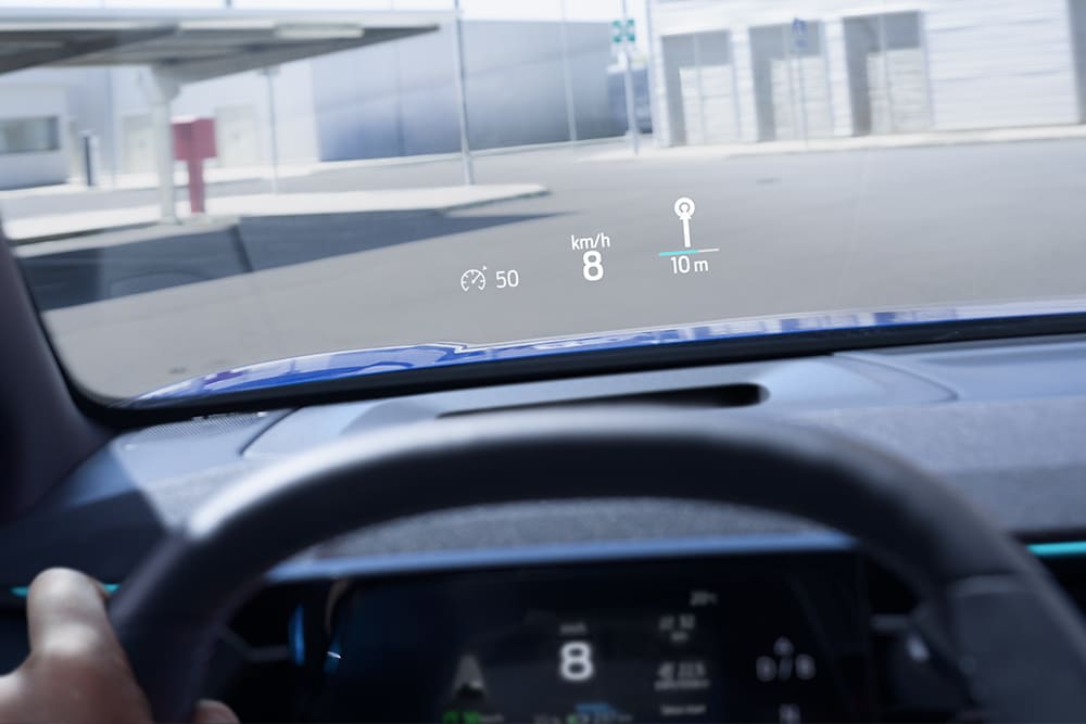 Primer plano de la pantalla digital Head-Up Display del Ford Capri® eléctrico que muestra información vital para la conducción.