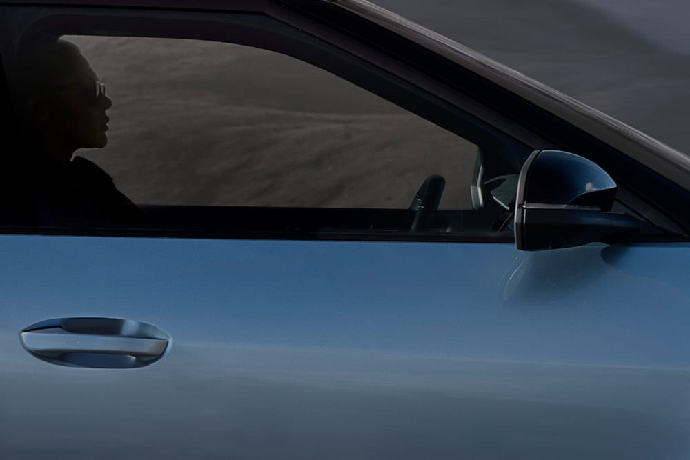 Close up view of the door of a blue Ford Explorer®. 