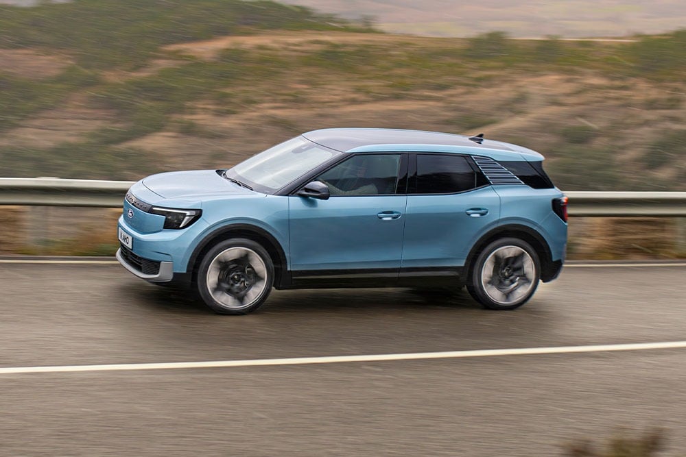 A blue Ford Explorer driving along a mountain road