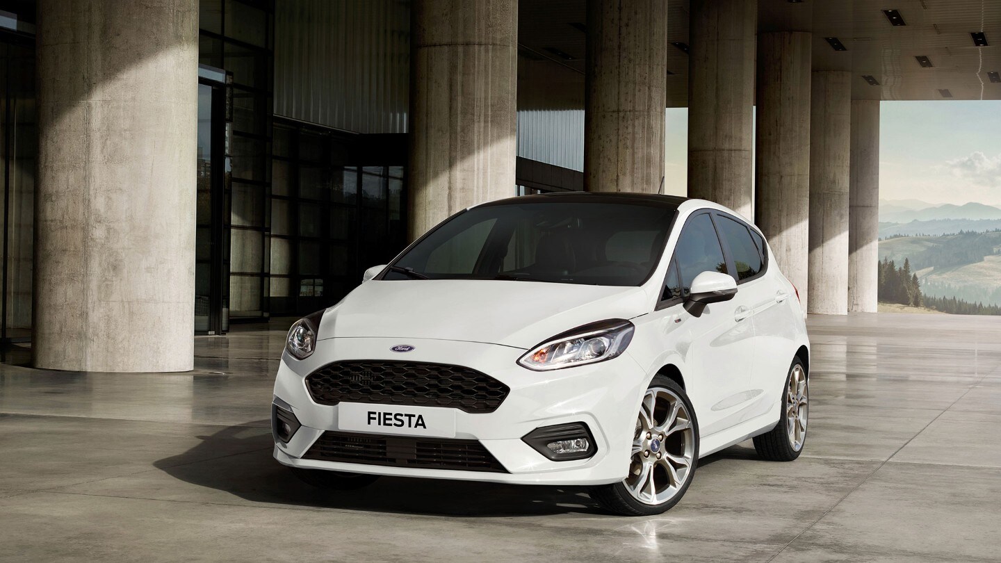 Ford Fiesta St-Line in white standing next to industrial building