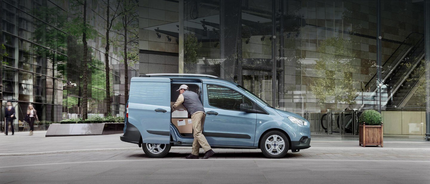 Blue Ford Transit Courier with delivery man Blue Ford Transit Courier with delivery man