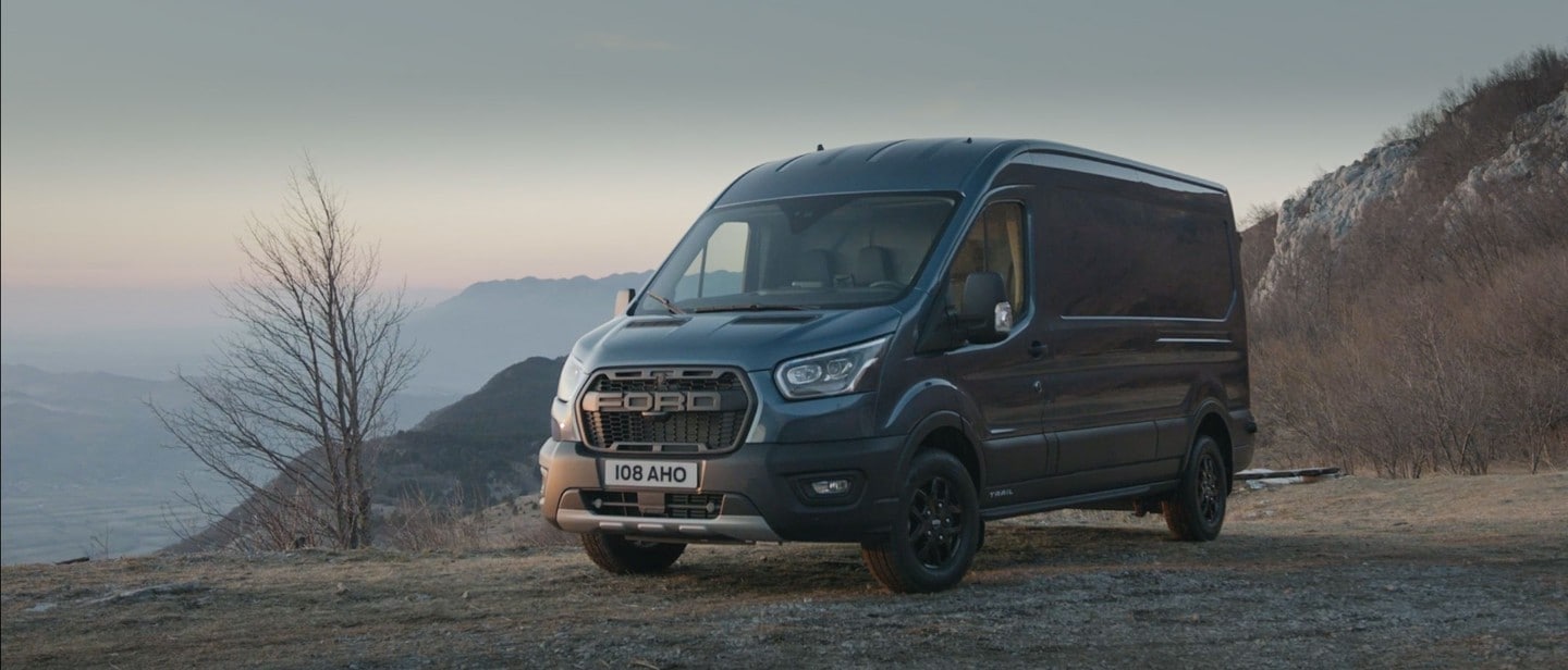 Blue Ford Transit Trail parked