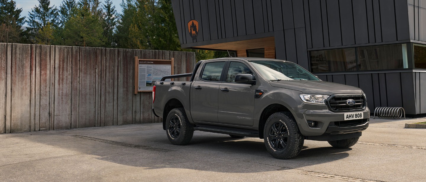 Grey Ford Ranger Wolftrak parked in front of a building