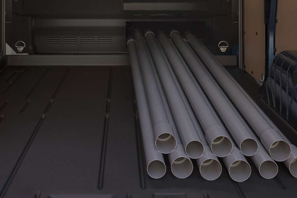 Tuberías cargadas dentro de una furgoneta eléctrica Ford E-Transit Custom.