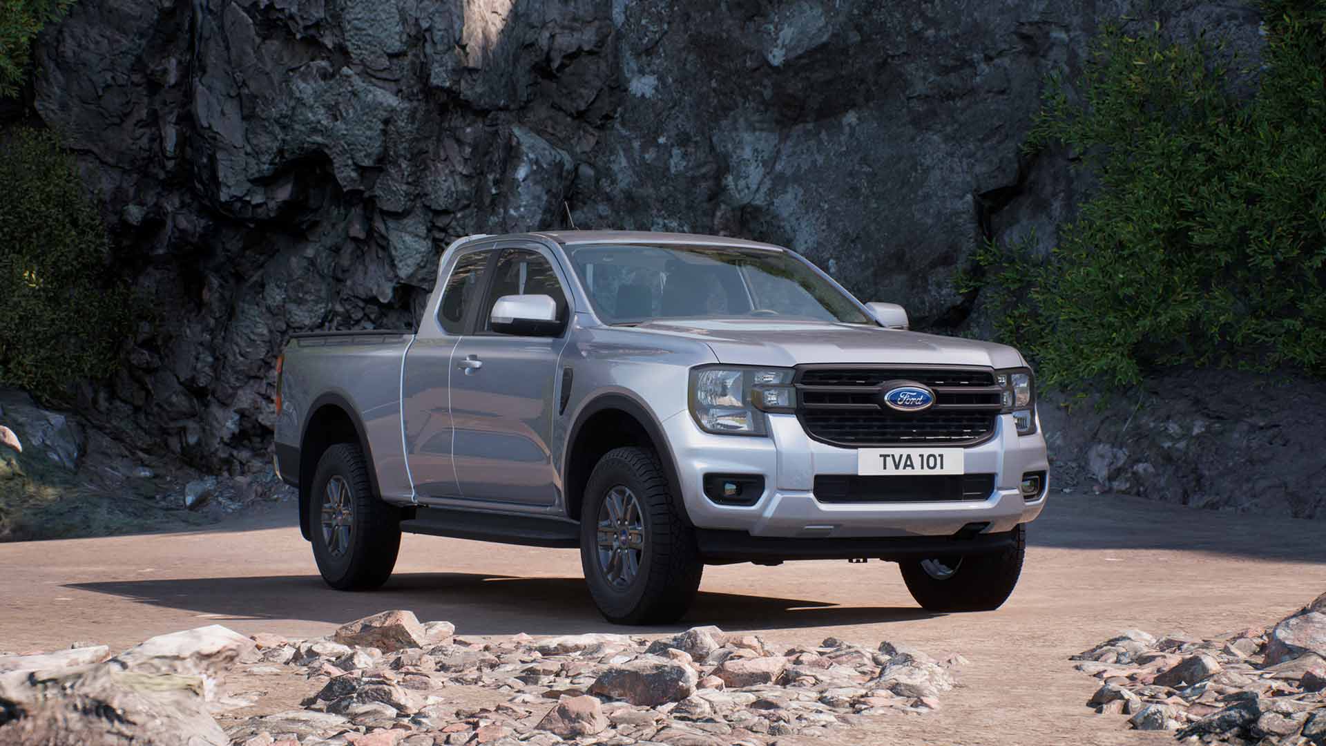 Un Ford Ranger XLT con cabina súper plateado aparcado en un terreno rocoso.